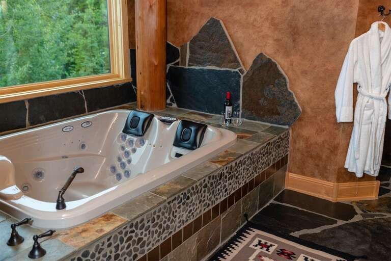 Relax after a day of adventure in the master ensuite`s oversized jetted-tub | Upper Level